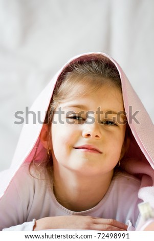 Little girl under blanket