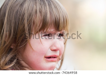 portrait of a cute little girl crying
