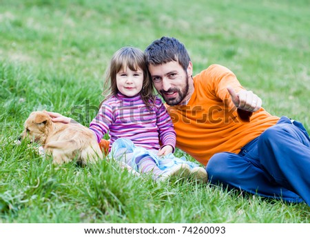 father and daughter on picnic - playing with dog