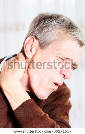 Senior man has a pain in the neck