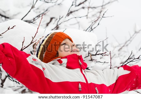 Happy Little boy having fun in the snow
