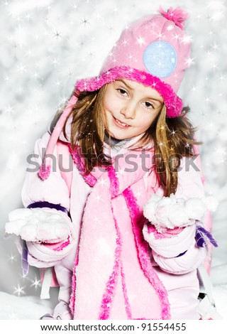 cute little girl in warm hat and gloves has a fun in snow