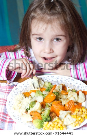 Little girl is getting ready to eat a healthy lunch of vegetables