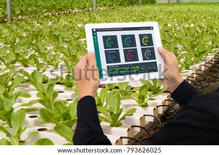 iot smart industry robot 4.0 agriculture concept,industrial agronomist,farmer using tablet to monitor, control the condition in vertical or indoor farm ,the data including Ph, Temp, Ic, humidity, co2
