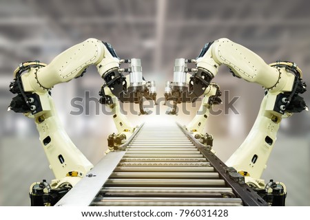 iot industry 4.0 technology concept.Smart factory using trending automation robotic arms with part on conveyor belt in operation line. Automotive manufacturing use it for precision, Repetition,intense