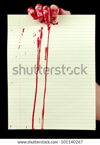 A blood covered hand holding up a piece of blood covered yellow lined paper isolated on black.