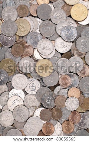 Large pile of Taiwanese coins shot from straight above. The pile includes 1, 5, 10 and 50 New Taiwan dollar coins.