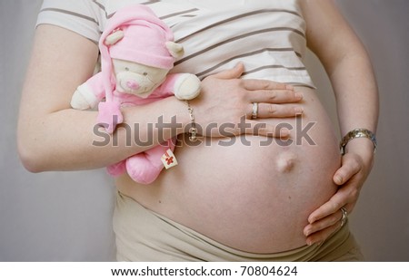 Pregnant woman with the first toy for her baby