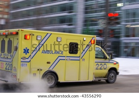 Ambulance car speeding blurred motion in american city on street warning lights flashing dramatic smoke