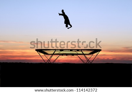 silhouette of trampoline gymnast in sunset