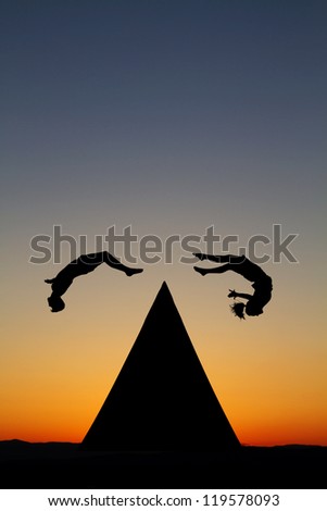 silhouetted parkour traceurs