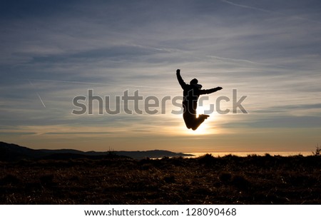 silhouette of man jumping in sunset