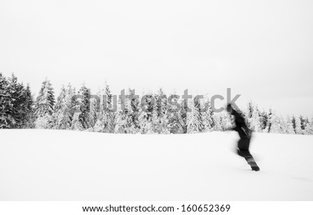 man running in snow with motion blur
