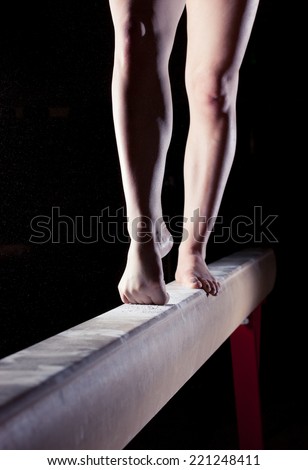 feet of gymnast on balance beam