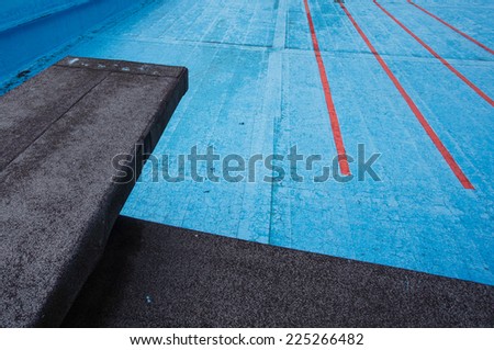 old empty pool with diving board