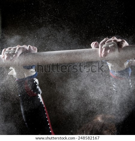 hands of gymnast with chalk on uneven bars