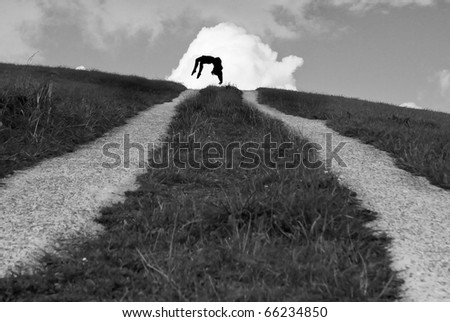 silhouette of female gymnast in sky at end of road