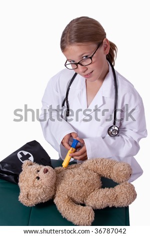 Cute little blond girl dressed up like a doctor holding a pretend needle and a brown teddy bear smiling