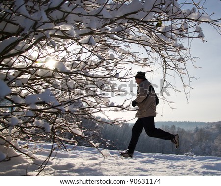 senior jogging in a snowy landscape