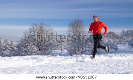 An athlete is jogging in a snowy landscape
