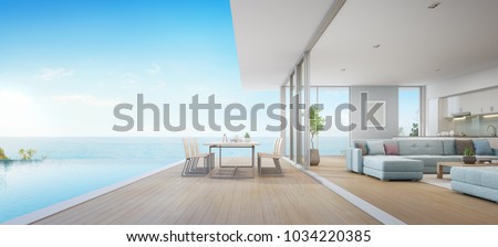 Outdoor dining and sea view living room beside kitchen of luxury beach house with terrace near swimming pool in modern design. Vacation home or holiday villa for big family. Interior 3d illustration.