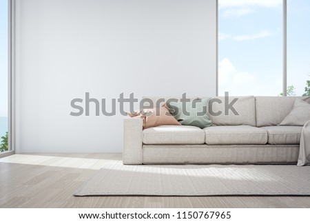 Sea view living room of luxury summer beach house with glass window and wooden floor. Empty white concrete wall background in vacation home or holiday villa. Hotel interior 3d illustration.