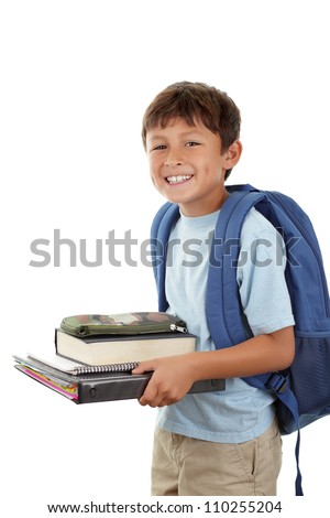 A young boy returns to school after the holidays in a cheerful mood - carrying his books
