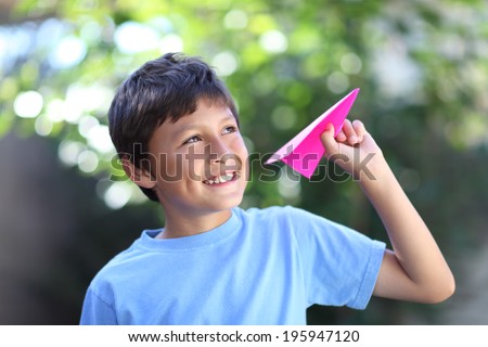 Boy playing with paper plane - with shallow depth of field