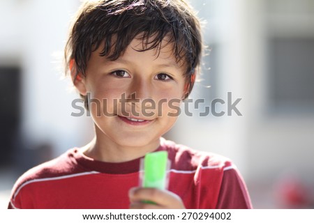Boy cools down with ice in the summer - shallow depth of field