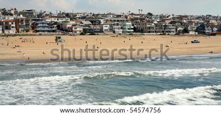 Panoramic view of Manhattan Beach in California showing surf, houses and skyline