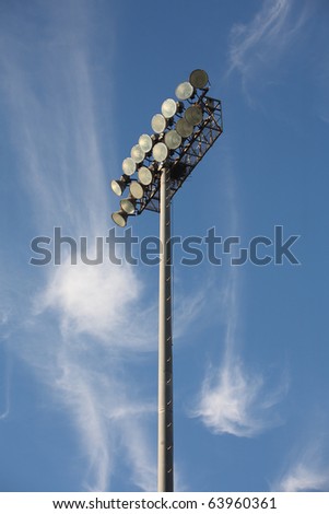 Soccer or Baseball Floodlights against a blue sky with strange cirrus cloud formations