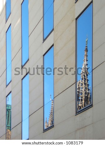 modern building in barcelona with cathedral reflected. Mix of new and old buildings