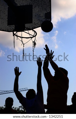 silhouette of a team playing basket