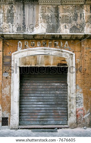 old business in the ghetto neighbourhood in Roma. Wall is dirty and broken