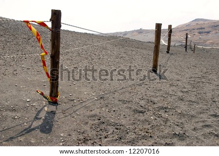 A view of a fence line in volcanic sand near Mount Aso on the Japanese island of Kyushu.