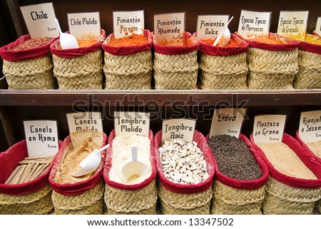 A view of a variety of spices on display in baskets for sale on a stand in an open air market in Granada, Andalucia, Spain.