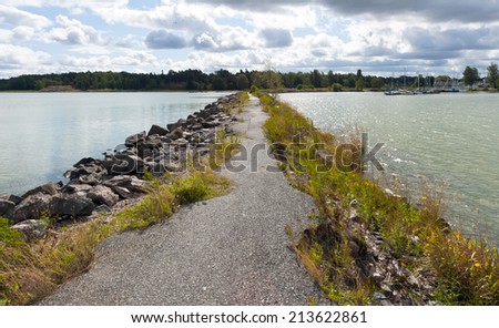 The landscape with a breakwater, a path and the sea. Sweden