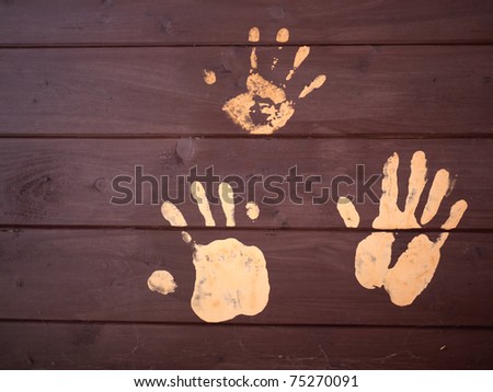 The handprints of mud on a wooden board