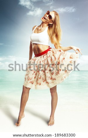 Woman in skirt and top in beach