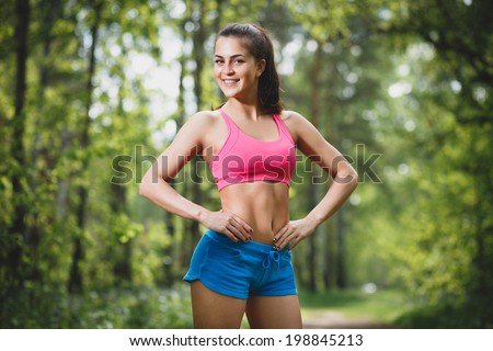 Young beautiful caucasian woman jogging in summer park