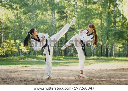 Two karate woman fighting on outdoor