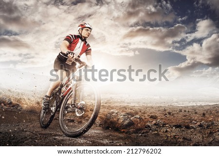 Mountain Bike cyclist riding single track above sunset valley