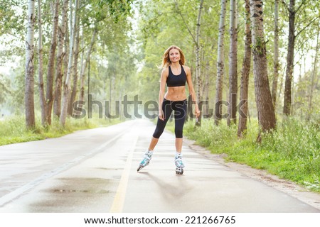 Roller skating sporty girl in otdoor. Caucasian woman in outdoor fitness activities.