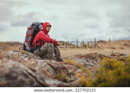 Adventure, travel, tourism, hike and people concept - man with backpack in mountain