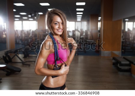 Fitness beautiful woman execute exercise with expander in gym. Stretch Band