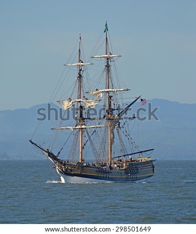ASTORIA, OREGON - JUNE 5, 2015: Sailors working in the rigging of a sailing vessel. The vessel is a recreation of an old ship that sells rides to tourists in the Pacific Northwest.