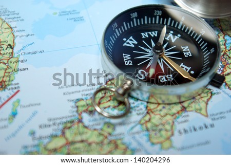 Magnetic compass on map with focus on scale