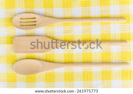 Wooden kitchen utensils in napkin. Top view