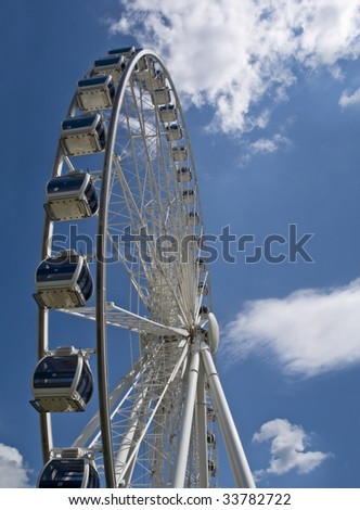 Sky Wheel in Niagara Falls (Canada) on a blue sky with white clouds. Vertical composition