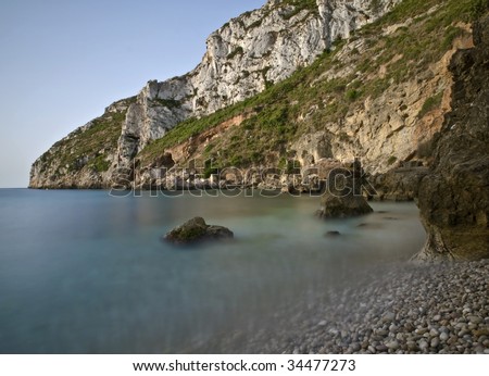 Beautiful cove in the Mediterranean sea, with the morning light.  Long time of exposure used to increase the sense of calm on the water.